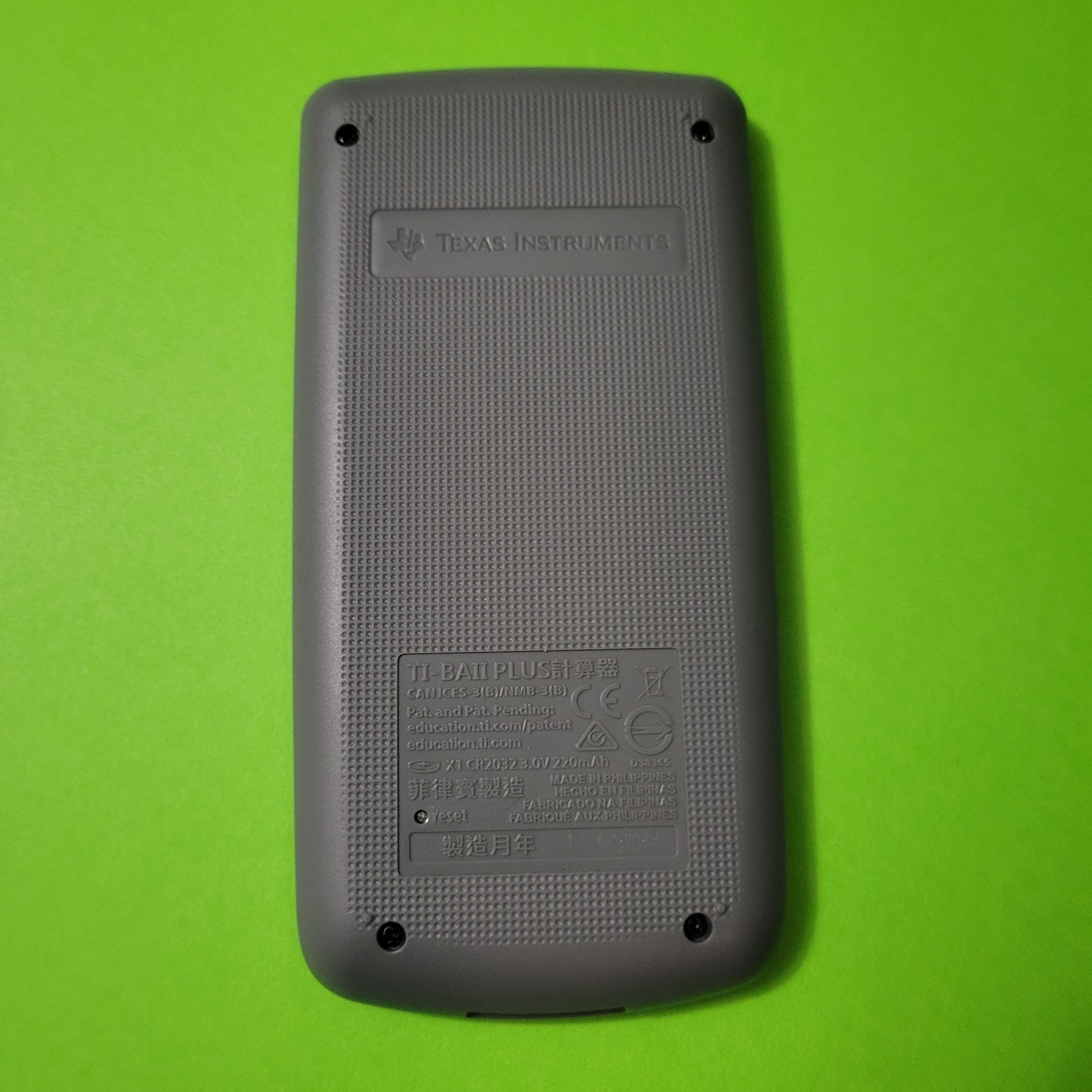 An image of the back of a texas instruments baii plus financial calculator